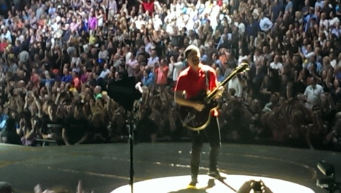 The Edge on stage with guitar